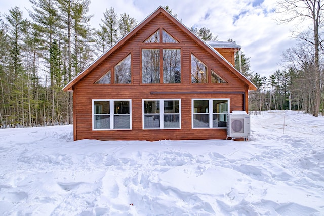 view of snow covered back of property