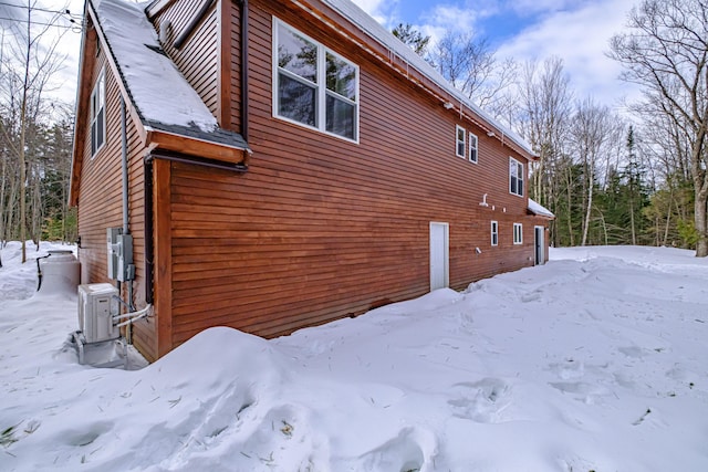 view of snow covered exterior featuring a garage