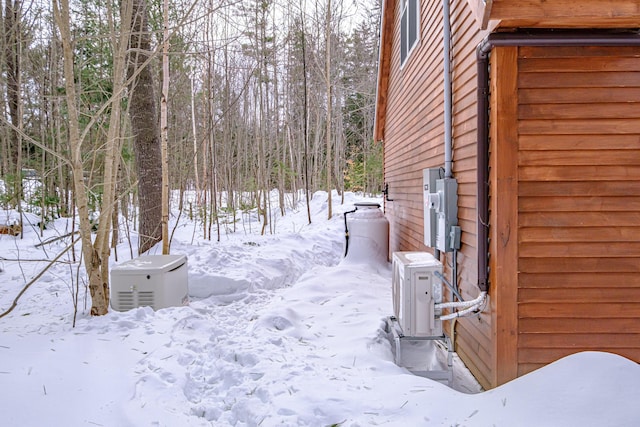 yard covered in snow featuring ac unit