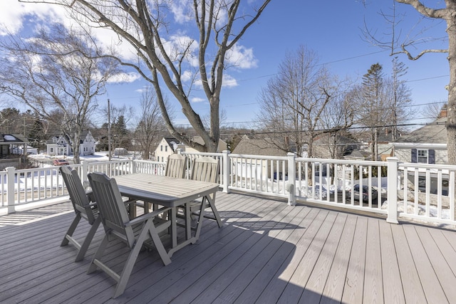 wooden terrace with outdoor dining area and a residential view