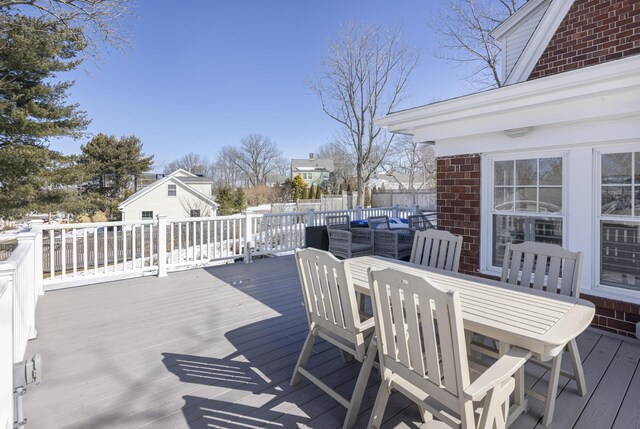 wooden deck featuring outdoor dining space and fence