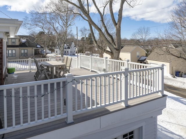 wooden terrace featuring a residential view and outdoor dining area