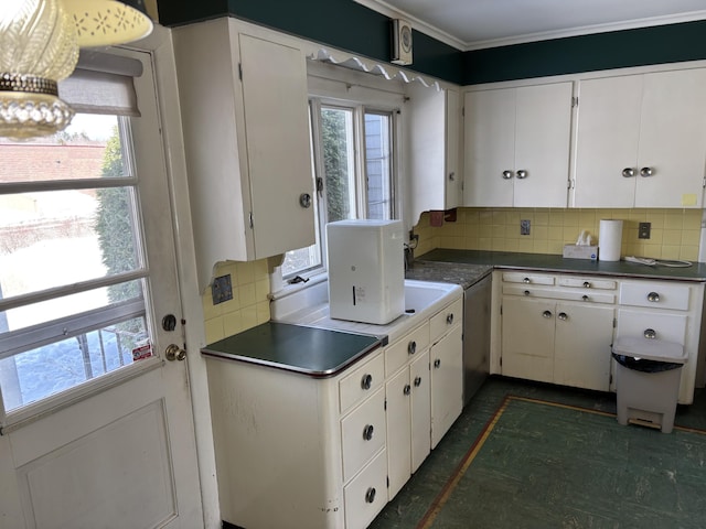 kitchen with dark countertops, white cabinetry, and decorative backsplash