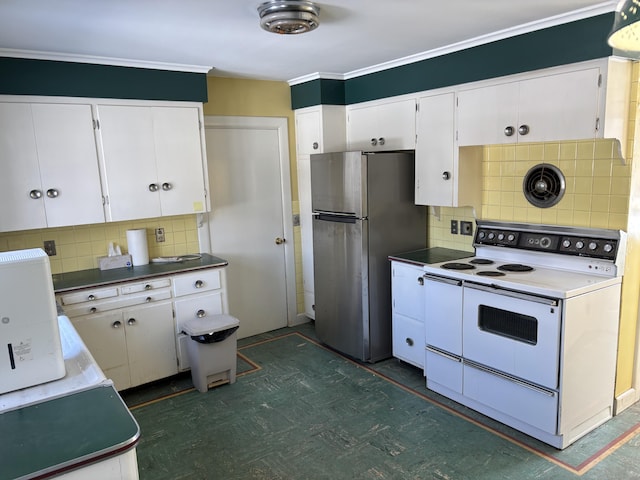 kitchen featuring tasteful backsplash, white cabinets, white electric range, and freestanding refrigerator