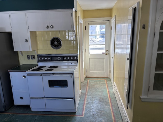 kitchen featuring white electric stove, white cabinets, backsplash, and freestanding refrigerator