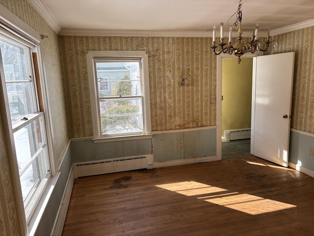 unfurnished dining area with a baseboard heating unit and wallpapered walls