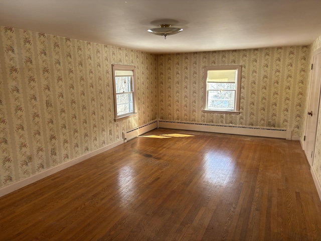 unfurnished room with wallpapered walls, a baseboard radiator, baseboards, and wood finished floors