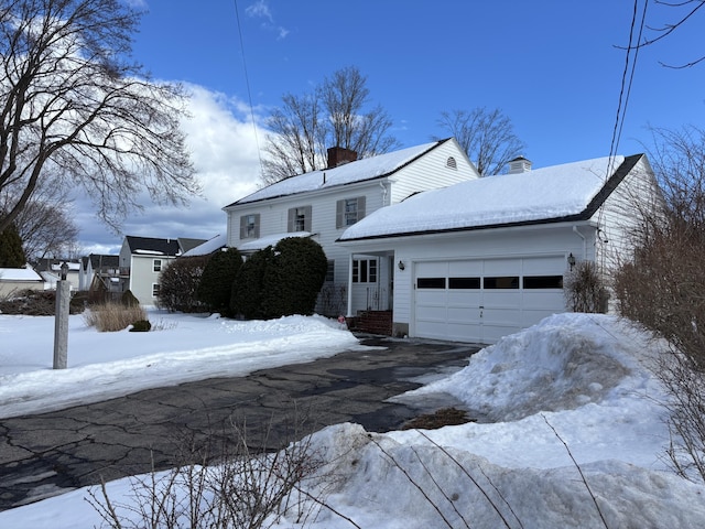 view of front of house with a chimney and an attached garage