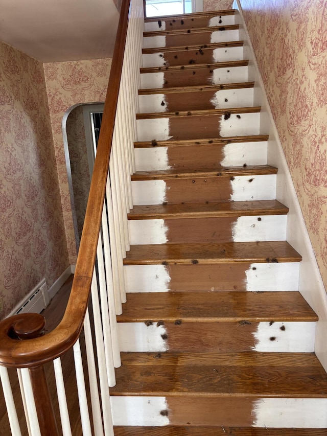 stairs with arched walkways and wallpapered walls