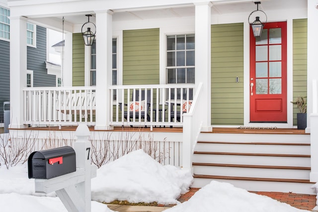 view of snow covered property entrance