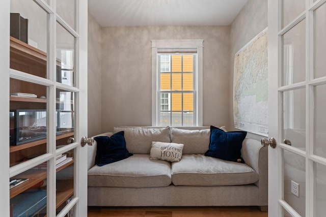 sitting room with french doors and wood finished floors