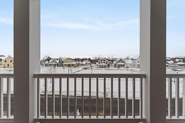 snow covered back of property with a residential view