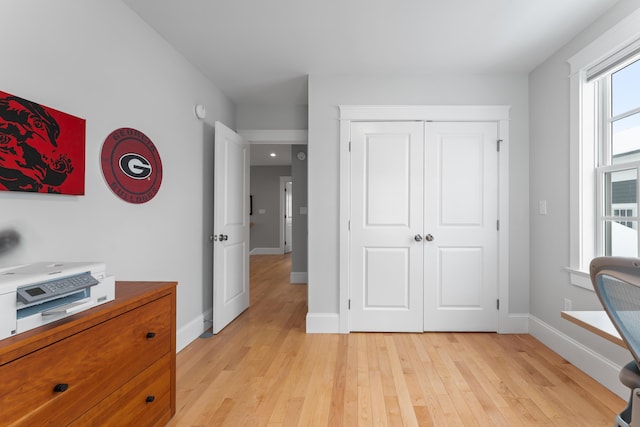 interior space featuring light wood-style floors and baseboards