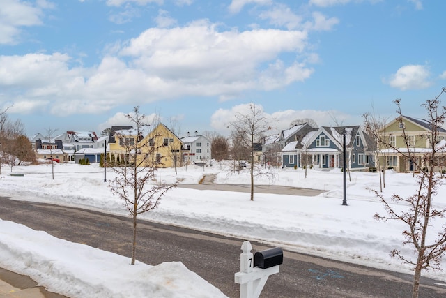 snowy yard with a residential view