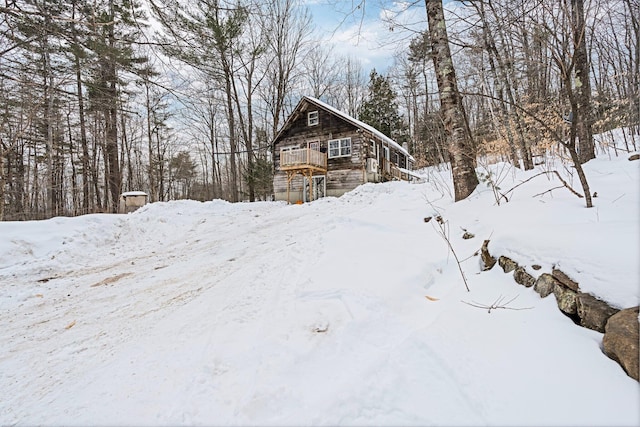 yard covered in snow with a garage and a wooden deck