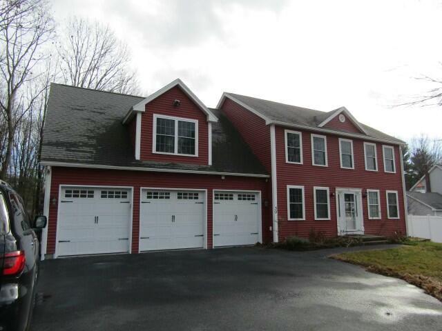 colonial home featuring driveway and an attached garage