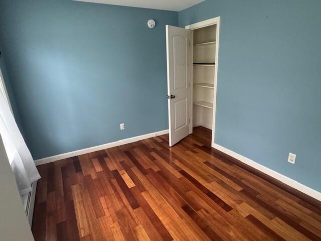 30 Hubbard St, Saco, ME 04072 - unfurnished bedroom featuring baseboards, dark wood-type flooring, and a closet