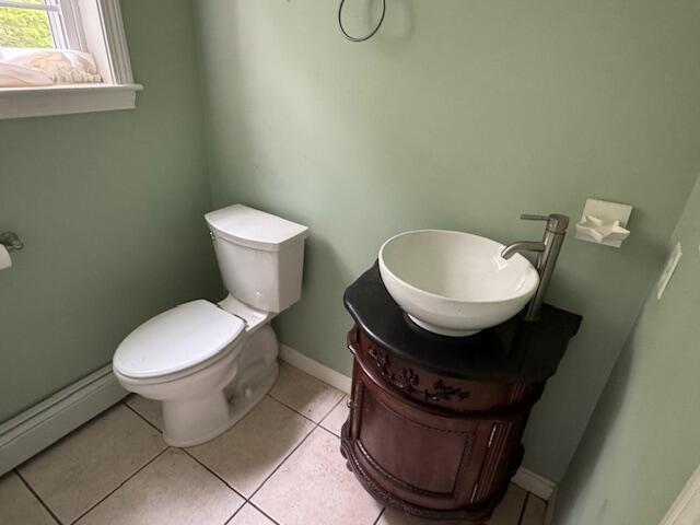 30 Hubbard St, Saco, ME 04072 - bathroom featuring baseboard heating, toilet, vanity, baseboards, and tile patterned flooring