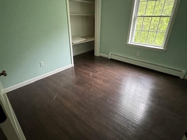 30 Hubbard St, Saco, ME 04072 - unfurnished bedroom with a baseboard heating unit, dark wood-type flooring, baseboards, and a closet