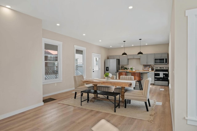 dining space featuring visible vents, baseboards, light wood-type flooring, and recessed lighting