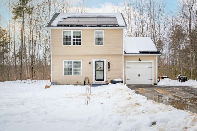 colonial-style house with an attached garage and solar panels