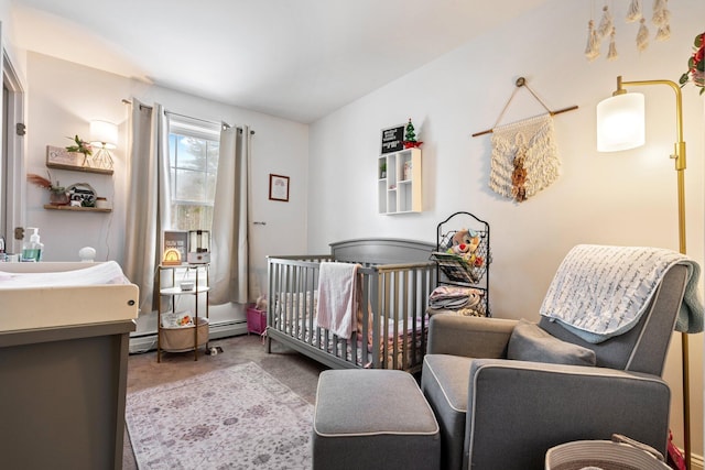 carpeted bedroom with a nursery area, a baseboard radiator, a baseboard heating unit, and a sink