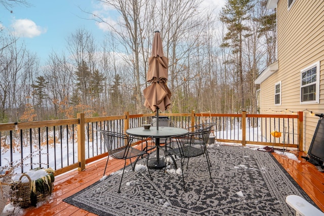 snow covered deck with outdoor dining space