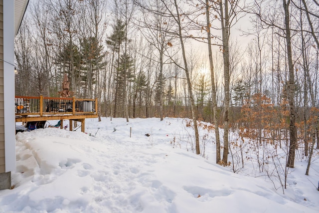 snowy yard with a wooden deck