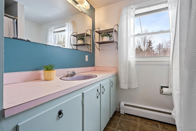 bathroom with vanity and baseboard heating