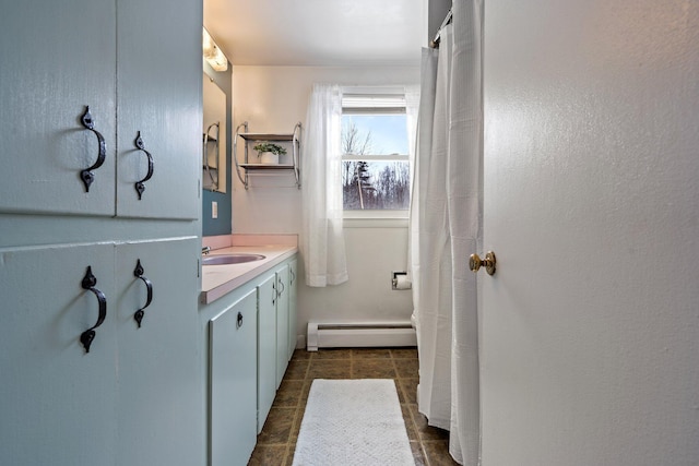 bathroom featuring baseboard heating, tile patterned flooring, and vanity