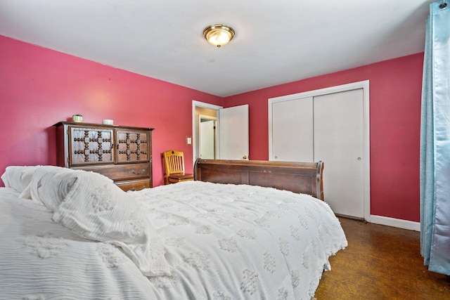 bedroom with a closet and baseboards