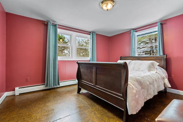 bedroom with a baseboard radiator and baseboards