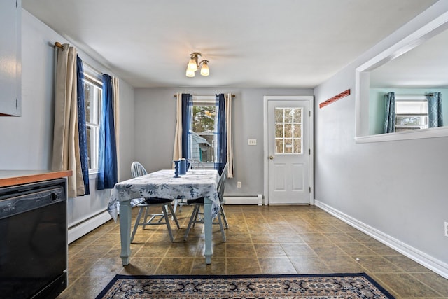 dining space featuring baseboard heating and baseboards