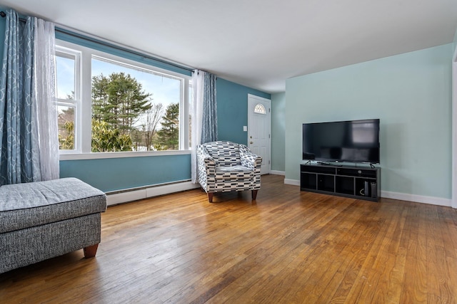 sitting room with hardwood / wood-style flooring, baseboards, and baseboard heating