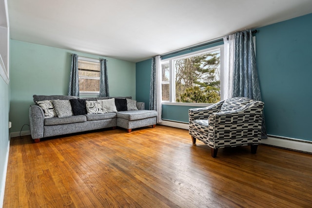 living room featuring wood-type flooring, baseboards, and baseboard heating