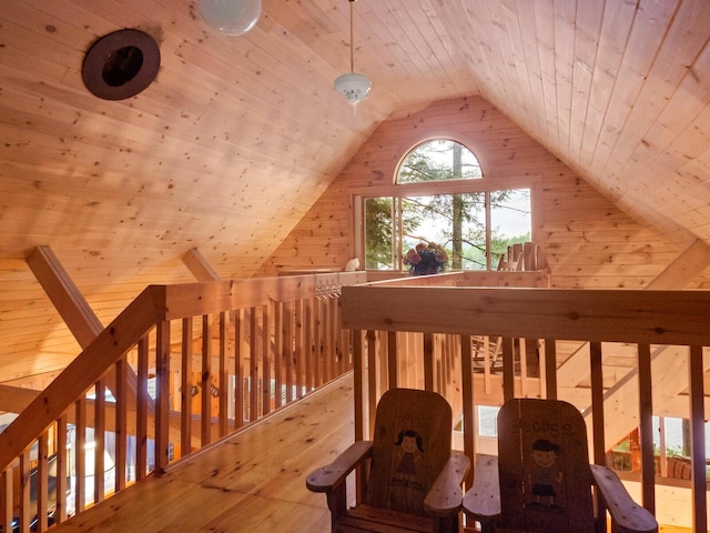 additional living space featuring lofted ceiling, hardwood / wood-style floors, wood walls, and wooden ceiling