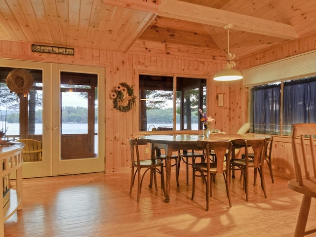 dining area featuring wood ceiling, wood walls, french doors, and wood finished floors