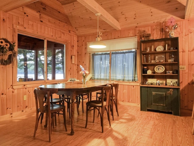 dining room featuring wooden ceiling, wooden walls, lofted ceiling with beams, and wood finished floors