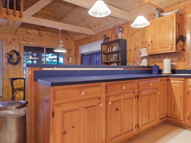 kitchen featuring dark countertops, wood ceiling, and wooden walls