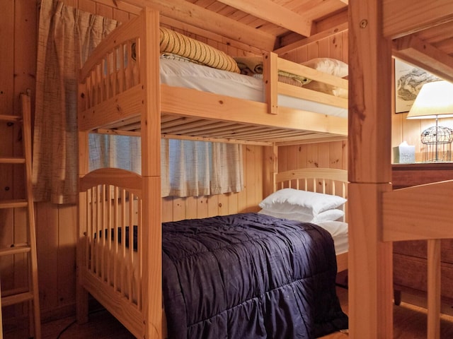 bedroom featuring wood walls