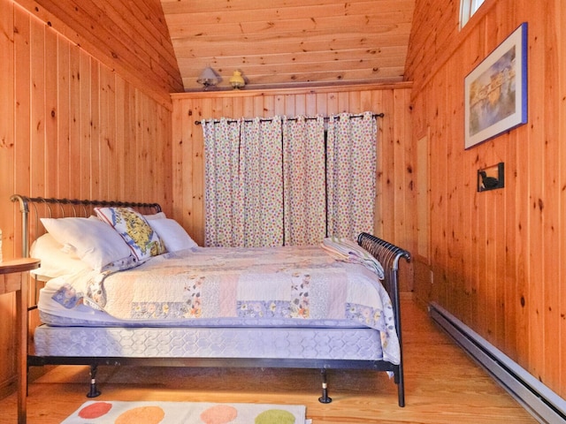 bedroom featuring wood walls, a baseboard radiator, vaulted ceiling, and wood finished floors