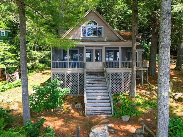 rustic home featuring a sunroom and stairs