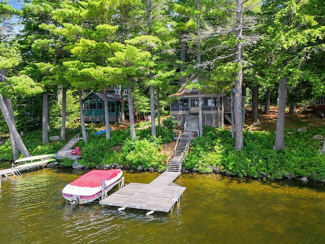 dock area featuring stairway and a water view