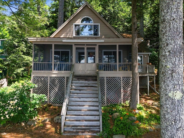 view of front facade featuring stairs and a sunroom