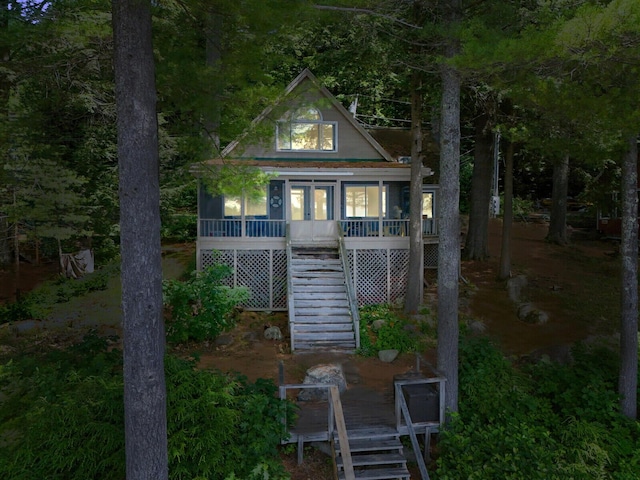view of outdoor structure with covered porch and stairs