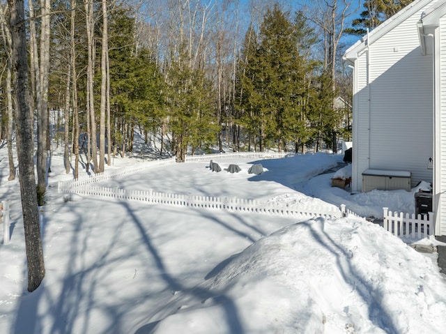 snowy yard with fence