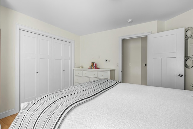 bedroom with light wood-style floors and a closet