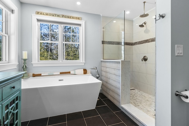 full bathroom with tile patterned floors, a freestanding tub, recessed lighting, and a walk in shower