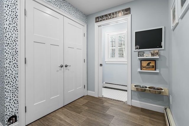 entryway with baseboards and a baseboard heating unit