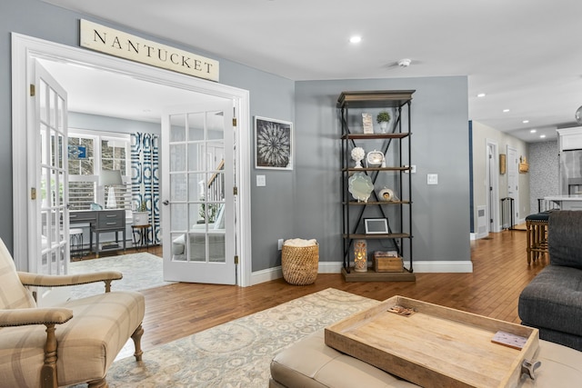 living area with baseboards, french doors, wood finished floors, and recessed lighting